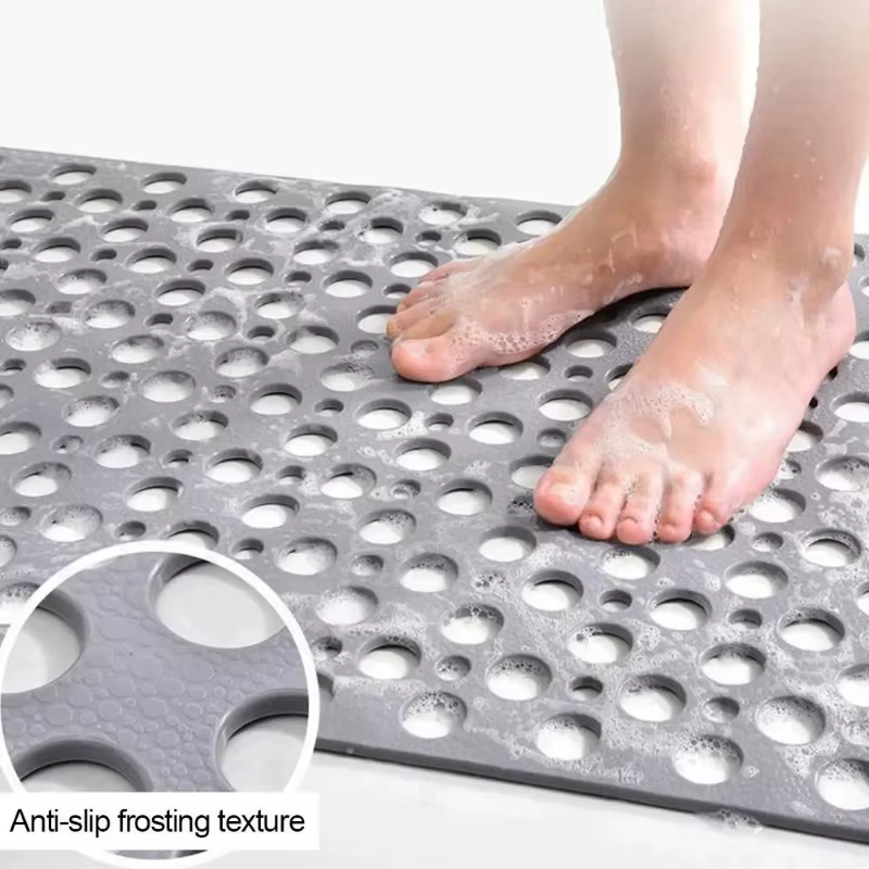 Tapis de bain avec trous de drainage